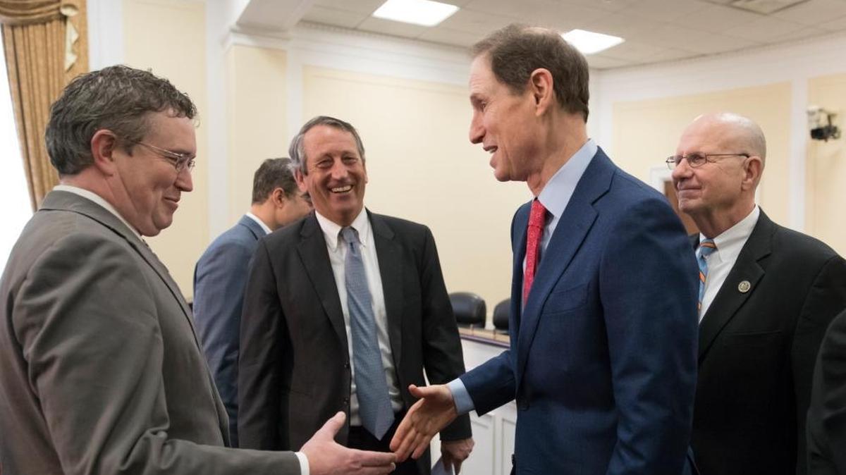 A bipartisan group of House and Senate lawmakers, from left, Rep. Thomas Massie, R-Ky., Rep. Mark Sanford, R-S.C., Sen. Ron Wyden, D-Ore., and Rep. Ted Poe, R-Texas, finish a news conference where they were united in their insistence on reforms to the FISA Amendments Reauthorization Act of 2017 to protect Americans' rights, at the Capitol in Washington, Wednesday, Jan. 10, 2018.