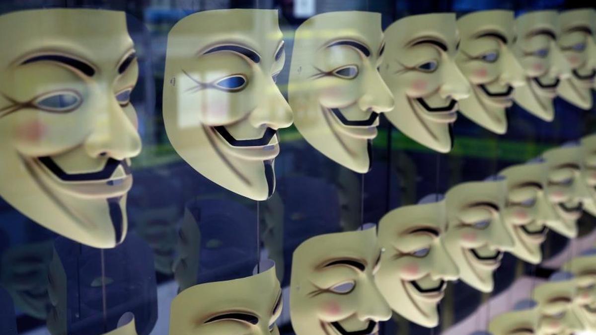 Guy Fawkes masks, often associated with the hacker group Anonymous, are displayed in a section about hacking at SPYSCAPE, a new attraction in New York City, on Feb. 12. Cybercrime may impose losses of up to $600 billion a year worldwide, a new report says.