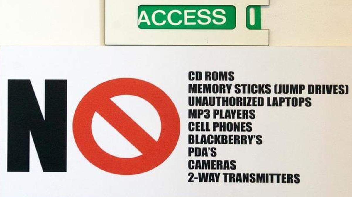 A sign on a door shows prohibited articles at the Industrial Control Systems Cyber Emergency Response Team Watch and Warning Center during the first tour of the government’s secretive cyber defense lab at the Idaho National Laboratory on Sept. 29, 2011, in Idaho Falls, Idaho.