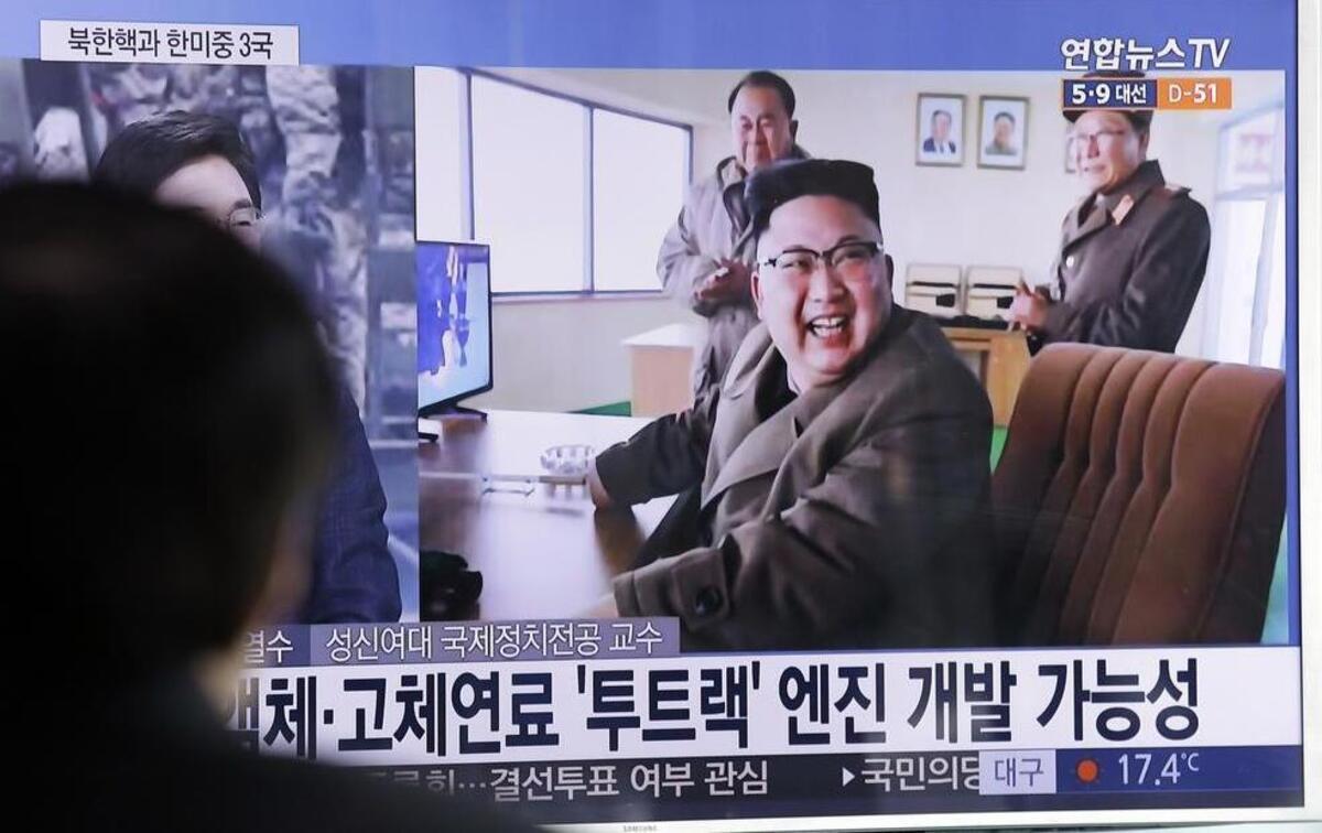 North Korean leader Kim Jong Un reacts to the successful test March 19 of a new type of high-thrust rocket engine. The letters read “New type engine.”