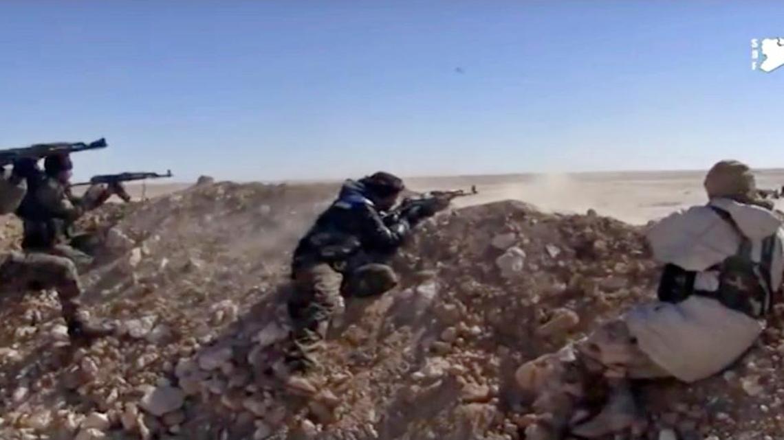 This frame grab from a video provided by the Syria Democratic Forces (SDF), shows fighters from the SDF opening fire on an Islamic State group's position, in Raqqa's eastern countryside, Syria, Monday, March 6, 2017.