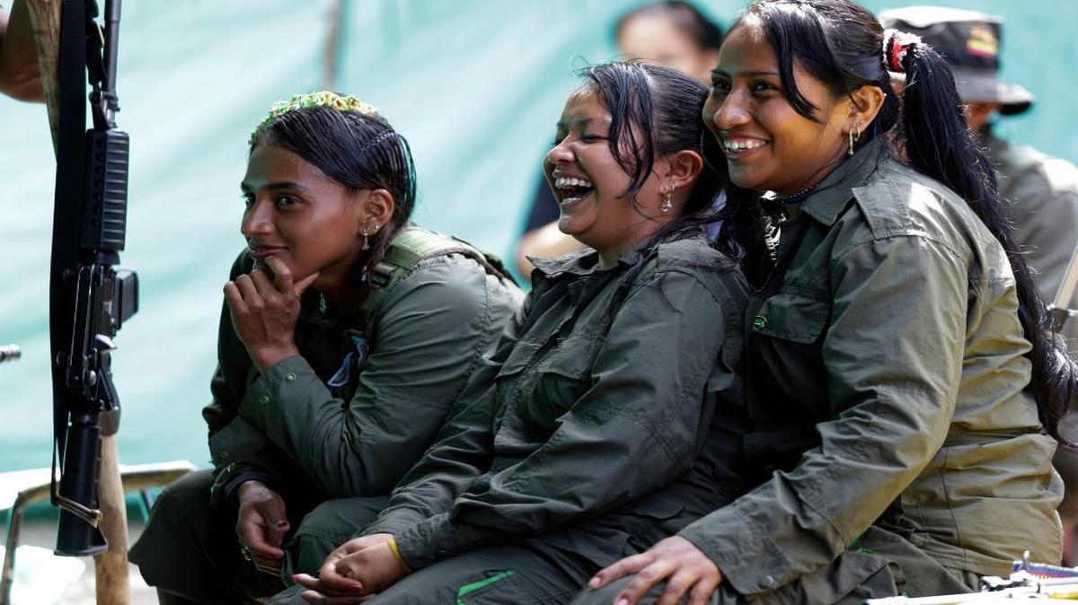 Revolutionary Armed Forces of Colombia rebels laugh during a break at their camp in the jungles of Putumayo, Colombia. The government of Colombia may not be able to depend on some U.S. aid to help rebels prepare for a life without arms.
