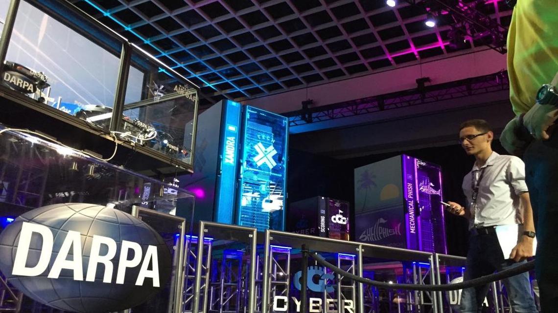 A programmer looks up at a stage containing seven supercomputers at a hotel in Las Vegas on Thursday, Aug. 4, 2016. The supercomputers were part of a tournament designed to show off computers’ capability for auto defense against viruses and malicious bugs.