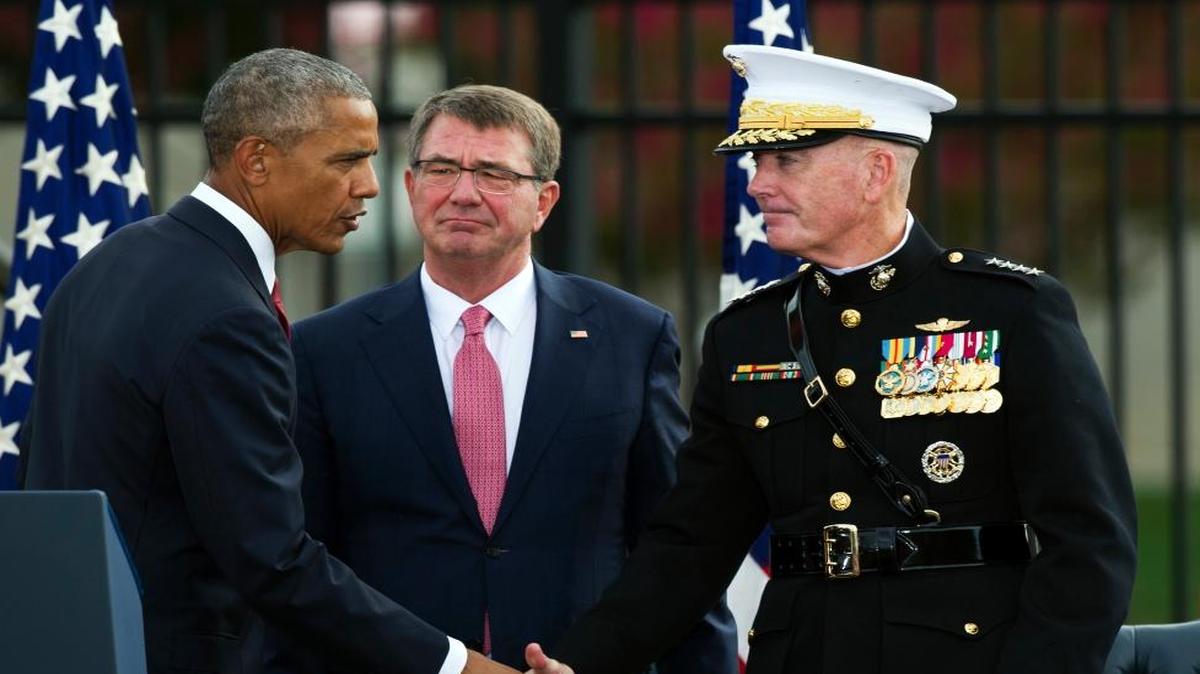 President Barak Obama shakes hands with Marine Corps Gen. Joseph Dunford, the chairman of the Joint Chiefs of Staff, as Secretary of Defense Ashton Carter looks on after delivering remarks at the Sept. 11 memorial observance ceremony at the Pentagon on Sunday, Sept. 11, 2016.