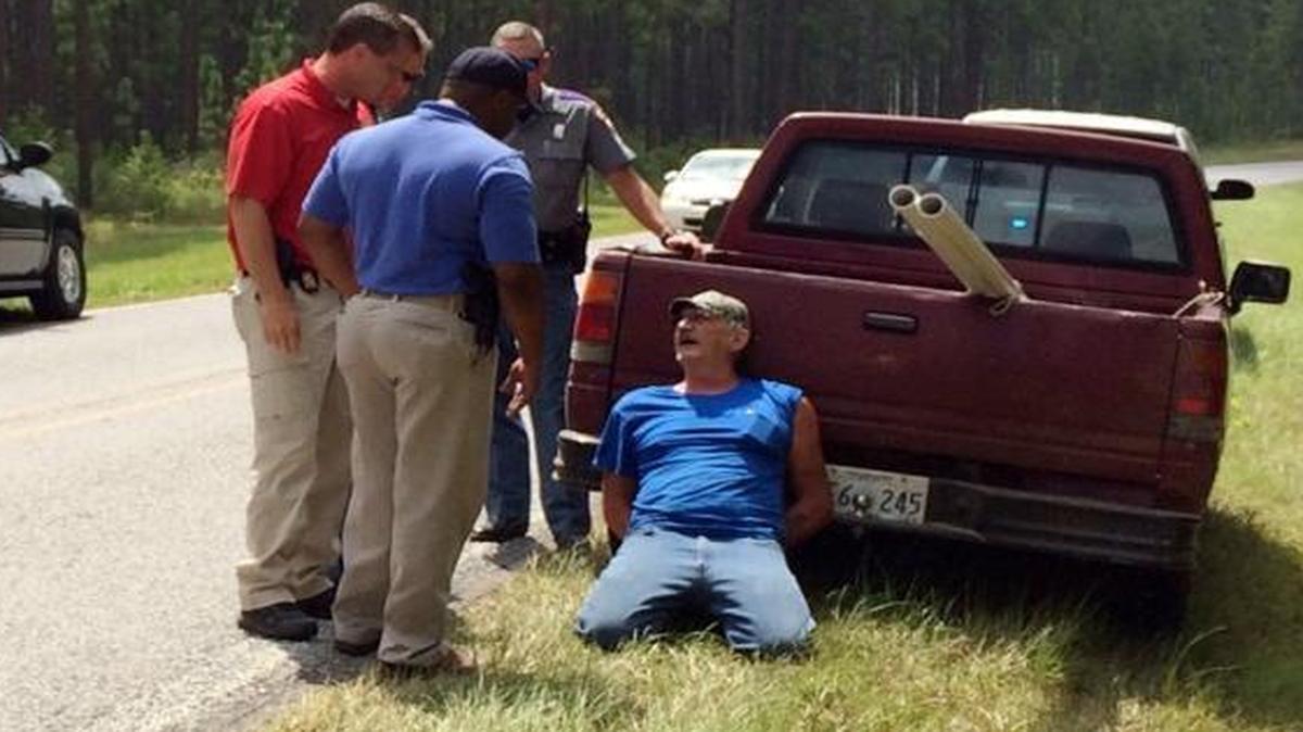 
Mississippi Bureau of Investigation agents and state troopers detained the man in the blue shirt after reportes that shots had been fired near Camp Shelby, a military training facility near Hattiesburg, Miss. Police later determined the noises had been the man’s truck backfiring.

