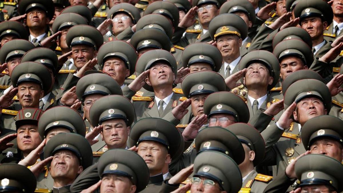 North Korean soldiers salute as their national anthem is played during a military parade to celebrate the 105th birth anniversary of Kim Il Sung, in Pyongyang on April 15, 2017. Analysts say North Korea is preparing for another test of a nuclear warhead, which may be timed as a show of force prior to South Korea’s May 9 presidential election.