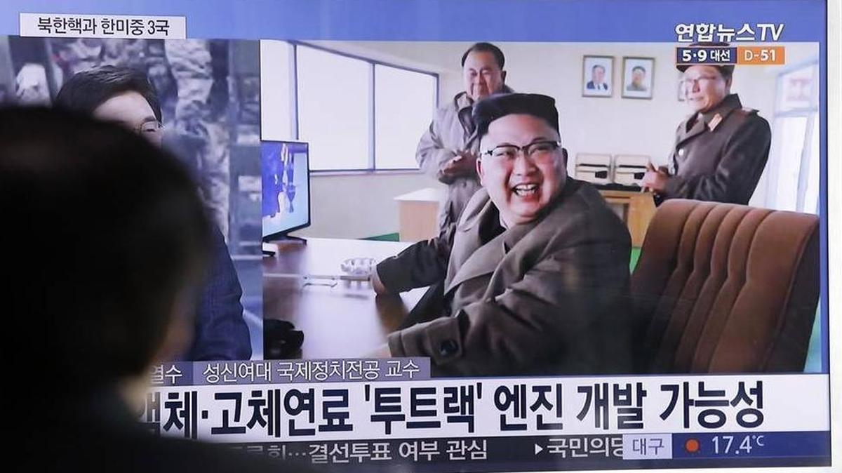 North Korean leader Kim Jong Un reacting to the successful test March 19, 2017, of a new type of high-thrust rocket engine. The letters read, “New type engine.”
