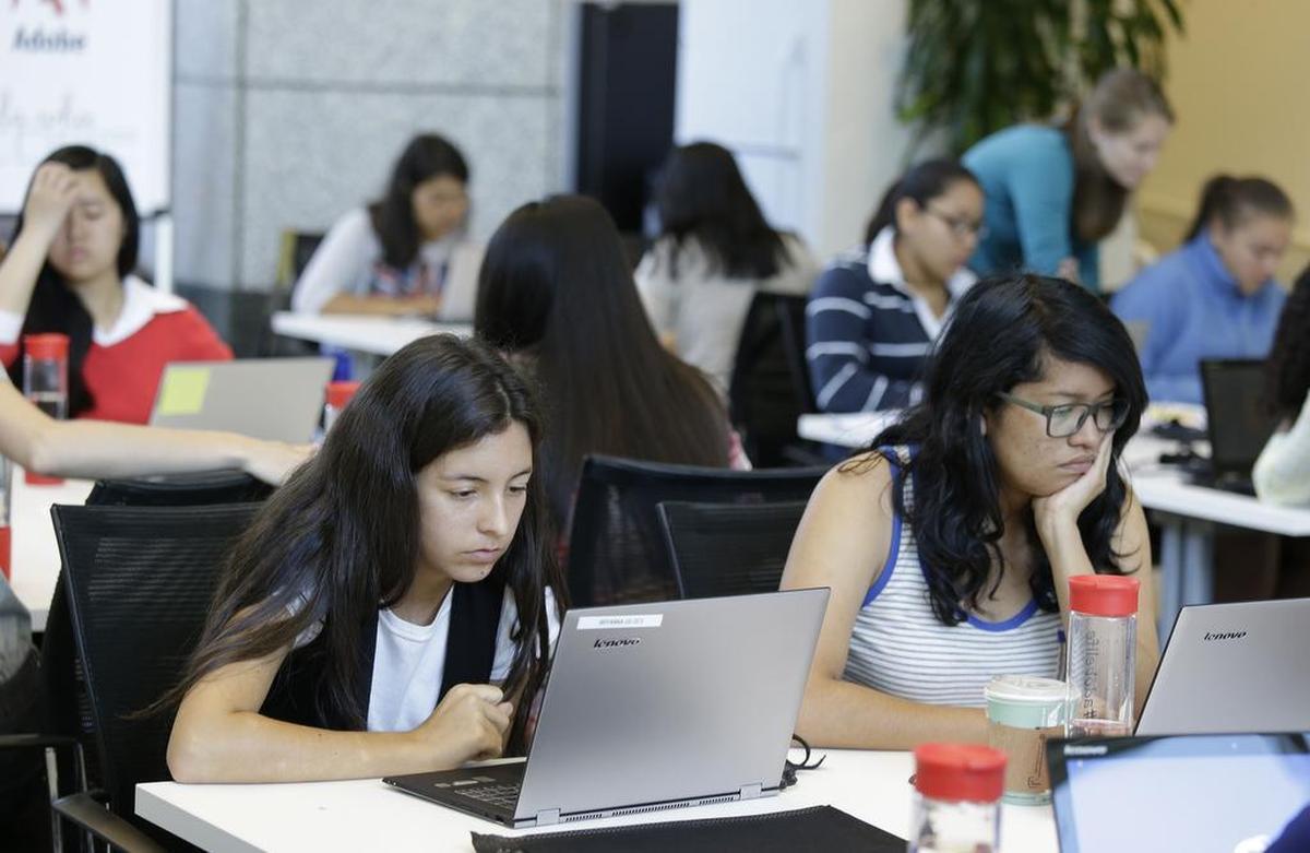 Bryanna Gilges, 15, left, and Yvonne Gonzalez, 17, right, work at completing an exercise during a Girls Who Code class at Adobe Systems in San Jose, Calif. Google is partnering with Girls Who Code, a national non-profit organization that aims to inspire, educate and equip young women for futures in the computing-related fields.