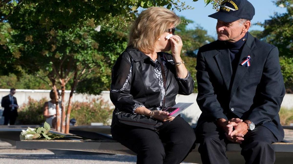 
Betsy Wolk, with her husband, Herb Wolk, of Columbia, Md., wipes her eyes as they visit the bench dedicated to their late son-in-law, Navy Lt. Darin Pontell, on Friday, Sept. 11, 2015, at the Pentagon Memorial on the 14th anniversary of the terrorist attacks on New York and Washington.
