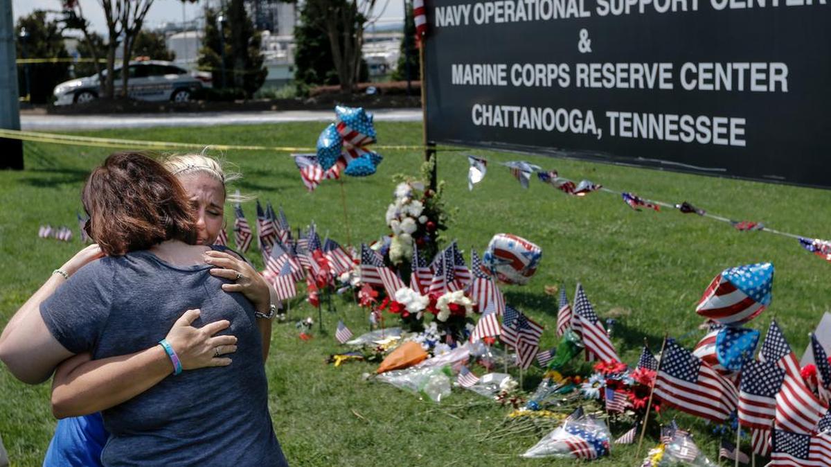 
Mourners embrace at a makeshift memorial at the Navy Operational Support Center and Marine Corps Reserve Center, in Chattanooga, Tenn., where five service members were fatally shot. Calls to allow members of the military to carry weapons on U.S. bases are viewed skeptically by senior commanders.
