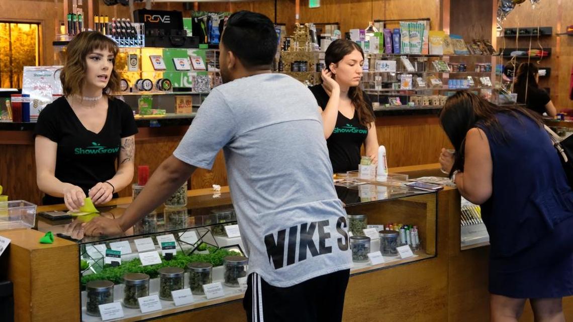 Customers at ShowGrow, a marijuana dispensary in downtown Los Angeles, shop for weed on April 20, 2017. Most cannabis businesses do all of their transactions in cash since banks shun enterprises that are illegal under federal law. The cannabis industry and many states are lobbying Congress to change U.S. law, so that state-approved marijuana businesses can use banks and become less vulnerable to robbers.
