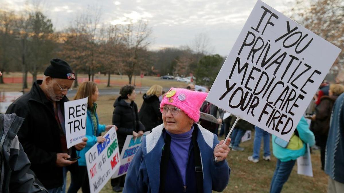 Protesters stand outside before New Jersey Rep. Leonard Lance's town hall meeting at Raritan Valley Community College, Wednesday, Feb. 22, 2017, in Branchburg, N.J.