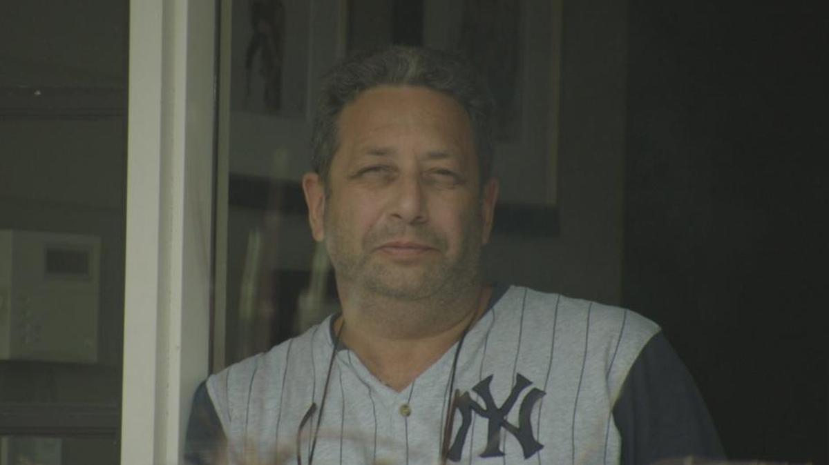 Felix Sater looks through the front door of his New York home earlier this year during an interview with Dutch broadcaster Zembla.