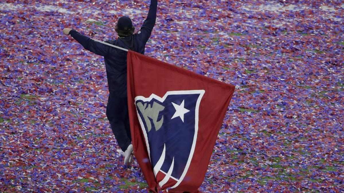 A man carries a New England Patriots flag after overtime of the NFL Super Bowl 51 football game between the Atlanta Falcons and the New England Patriots Sunday, Feb. 5, 2017, in Houston.
