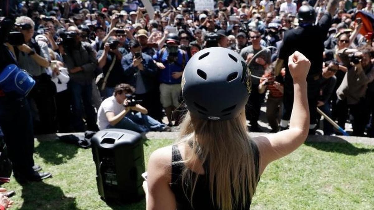 Lauren Southern wears a protective helmet as she speaks during a rally for free speech Thursday, April 27, 2017, in Berkeley, Calif. Demonstrators gathered near the University of California, Berkeley campus amid a strong police presence and rallied to show support for free speech and condemn the views of Ann Coulter and her supporters.