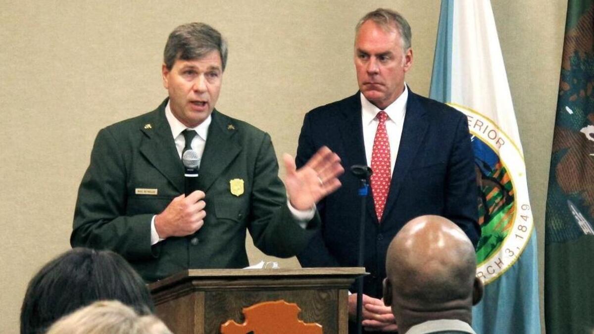 National Park Service acting director Mike Reynolds, left, and Interior Secretary Ryan Zinke address Park Service employees at Grand Canyon National Park, Ariz., on Friday, Oct. 13, 2017. A watchdog group has accused the Interior Department of illegally relying on temporary agency directors. Reynolds, for instance, served 386 days in an acting capacity, even though the law says the maximum tenure is only 300 days.