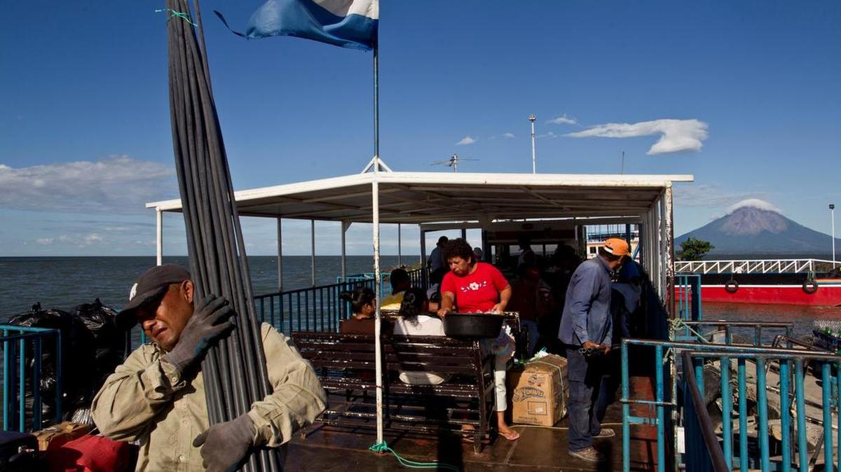 A worker carries construction material on a ferry in Lake Nicaragua or Cocibolca Lake, a body of water that could be a possible part of a planned Inter-Oceanic canal in Rivas, Nicaragua.