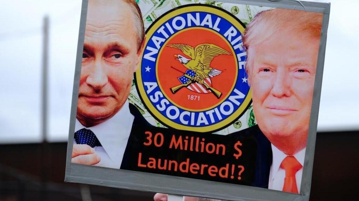 Protesters carried this sign denouncing possible ties between Russia and the National Rifle Association during a demonstration on Feb. 3, 2018 in Portland, Ore.
