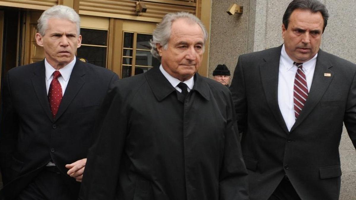 In this March 10, 2009, file photo, Bernard Madoff exits Manhattan federal court in New York. Federal regulators reached a settlement with Madoff on June 16, 2009, that prohibits him from working in the securities industry.