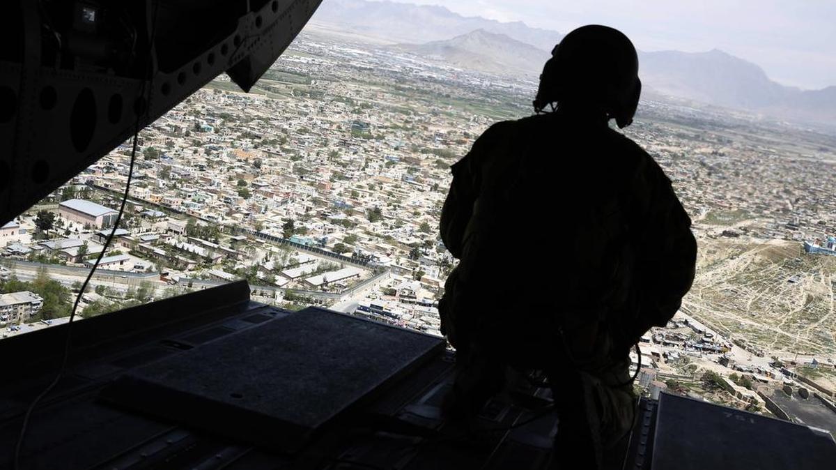 A U.S. soldier mans a gun at the back gate aboard the helicopter carrying U.S. Defense Secretary Jim Mattis as Mattis arrives via helicopter at Resolute Support headquarters in Kabul, Afghanistan Monday, April 24, 2017.