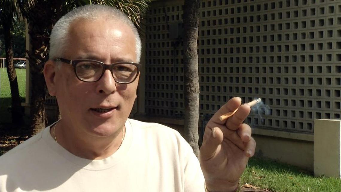 Gerardo Barro enjoys a cigarette outside Miami’s Robert King High Towers public housing complex. The Department of Housing and Urban Development proposed a rule Thursday that would require the more than 3,100 public housing agencies across the country to make their properties smoke-free.