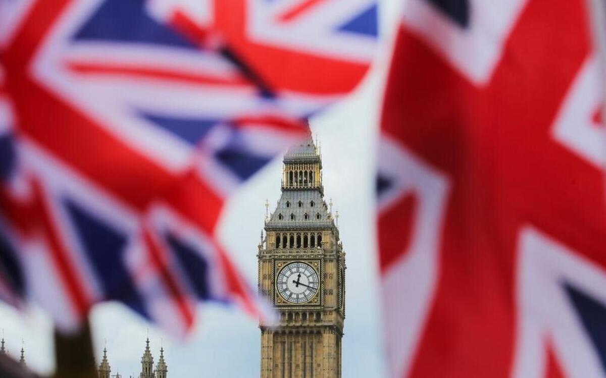 The British national flag flies in front of the Big Ben clock tower on June 24, 2016, in London.