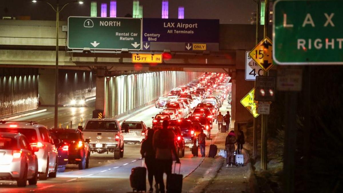 Reports of a gunman opening fire that turned out to be false caused panicked evacuations at Los Angeles International Airport on Sunday night, while flights to and from the airport were delayed. A search through terminals brought no evidence of a gunman or shots fired, Los Angeles police spokesman Andy Neiman said. (AP Photo/Ringo H.W. Chiu)