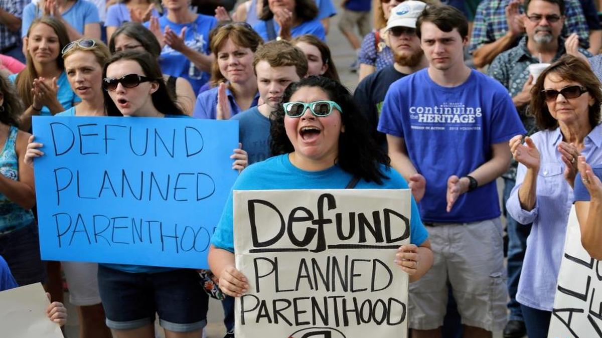 In this July 28, 2015, file photo, Erica Canaut, center, cheers as she and other anti-abortion rights activists rally on the steps of the Texas Capitol in Austin, Texas.
