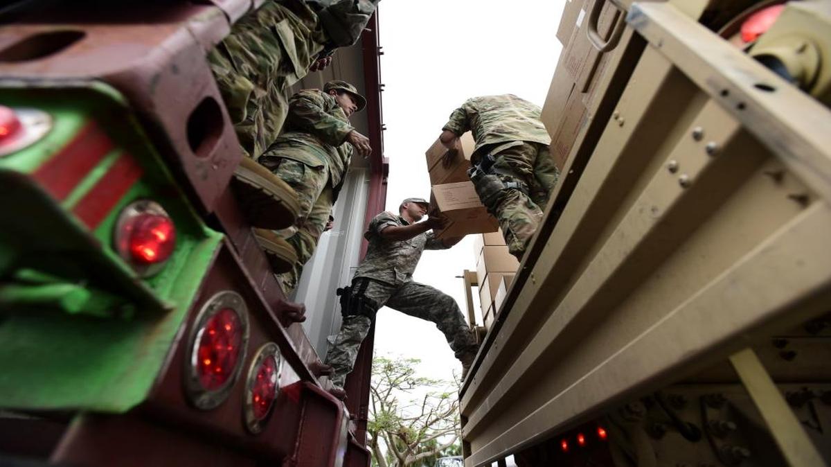 Soldiers and National Guard organize aid for the Santa Ana community in the aftermath of Hurricane Maria in Guayama, Puerto Rico, Thursday.
