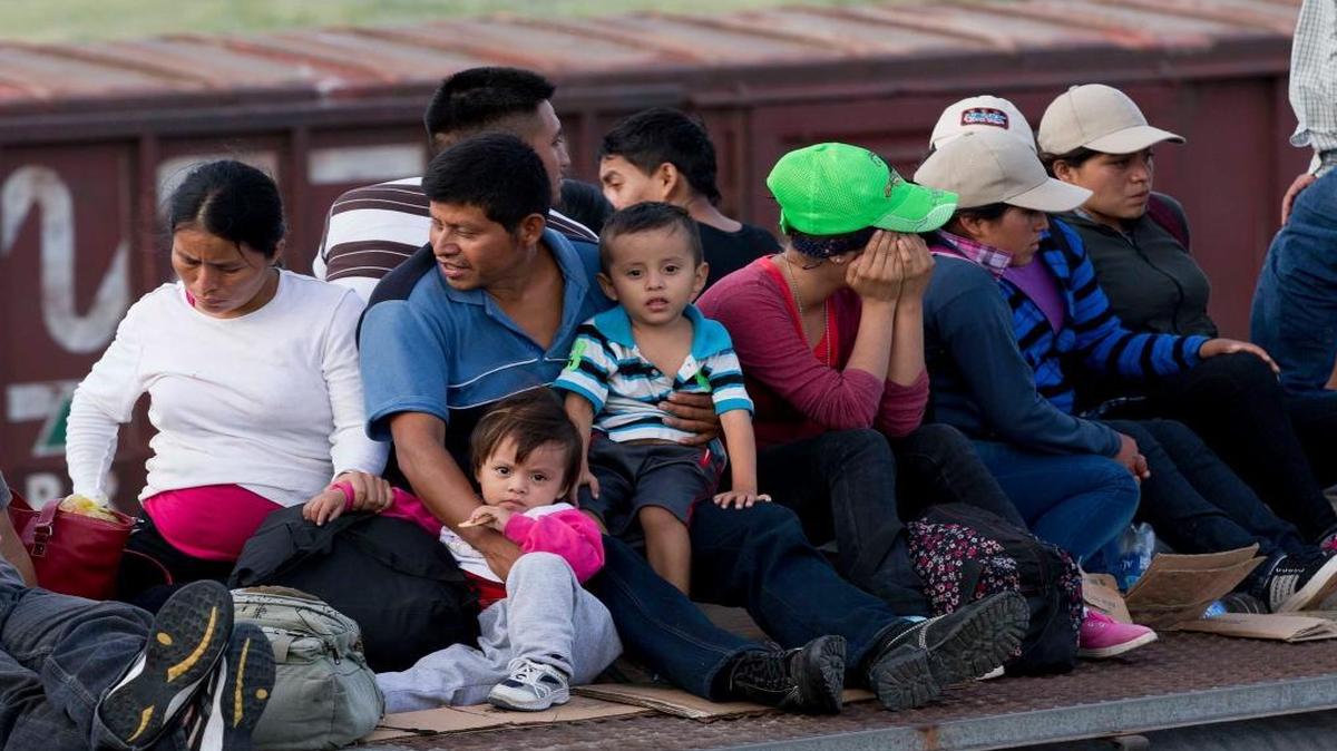 Central American migrants ride a freight train during their journey toward the U.S.-Mexico border in Ixtepec, Mexico on July 12, 2014. In response to a new surge of migrants, the Obama administration has stepped up its efforts to save its federal family detention program. (AP Photo/Eduardo Verdugo)
