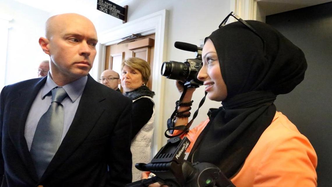 Micah Forrest blocks then-journalism-student Noor Tagouri from filming outside the courtroom of Chancellor Robert Corlew III, in Murfreesboro, Tenn., on March 24, 2014, after Corlew excused himself from a case challenging the Islamic Center of Murfreesboro cemetery approval by the Rutherford County Board of Zoning Appeals at the Rutherford County Judicial Building.
