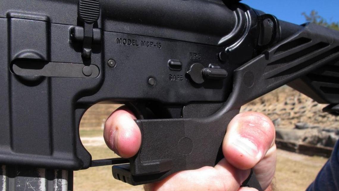 Shooting instructor Frankie McRae demonstrates the grip on an AR-15 rifle fitted with a bump stock at his 37 PSR Gun Club in Bunnlevel, N.C.