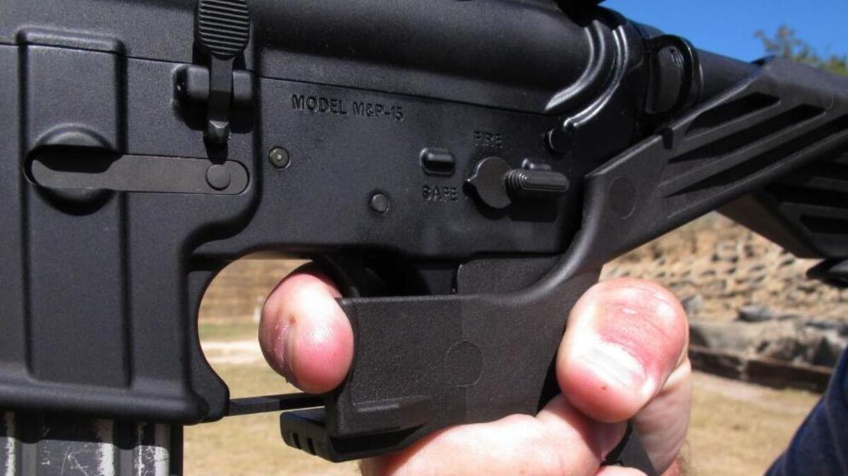 Shooting instructor Frankie McRae demonstrates the grip on an AR-15 rifle fitted with a bump stock at his 37 PSR Gun Club in Bunnlevel, N.C.