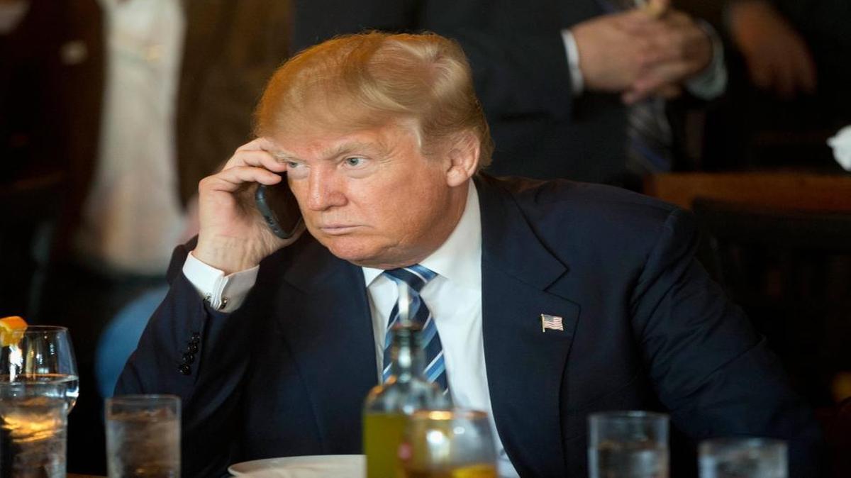 In this Feb. 18, 2016 file photo, Republican presidential candidate Donald Trump listens to his mobile phone during a lunch stop in North Charleston, S.C.