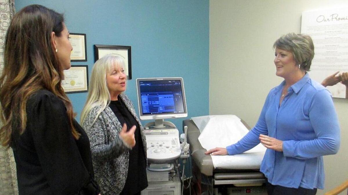 Blayne Wittig, executive director of Options for Women of California, left, a center in Concord, Calif., Debbie Whittaker, nurse manager, center, and Christine Vatuone, president and CEO of Informed Choices, talk at Informed Choices, a crisis pregnancy center in Grilroy, Calif.