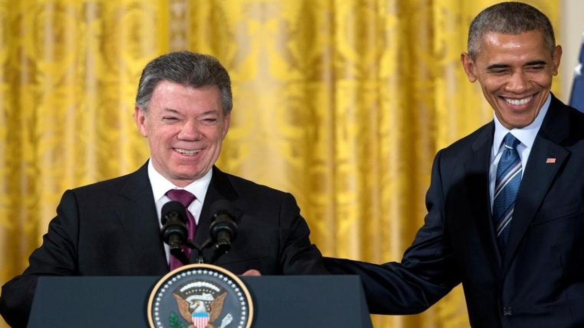 President Barack Obama, right, stands with Colombian President Juan Manuel Santos at a reception for Plan Colombia, the joint effort to create a safer, more prosperous future for Colombians, in the East Room of the White House in Washington on Thursday, Feb. 4, 2016.