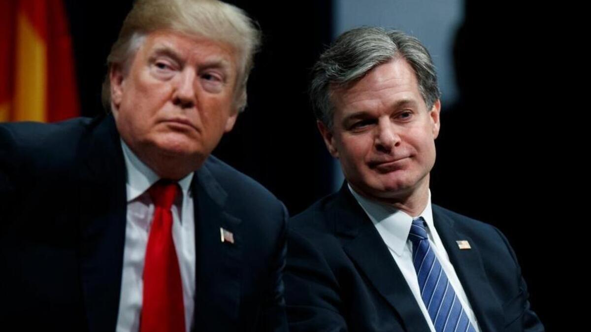 President Donald Trump sits with FBI Director Christopher Wray during the FBI National Academy graduation ceremony on Friday, in Quantico, Va.