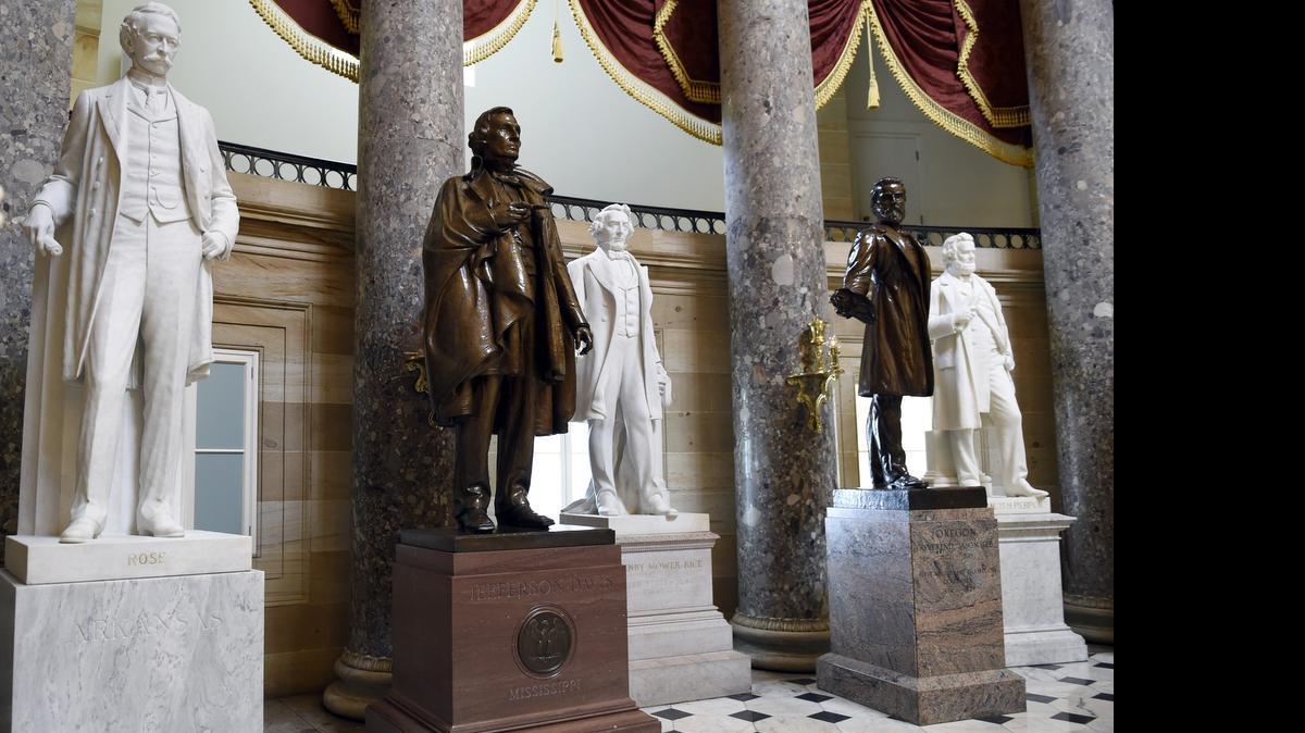 
A statue of Jefferson Davis, second from left, is on display in Statuary Hall on Capitol Hill in Washington, Wednesday, June 24, 2015. Many of America’s military bases are named for commanders who were associated with Davis and fought for the South during the Civil War, including Gen. Braxton Bragg and Gen. John Bell Hood. Associates of Gen. Robert E. Lee who have bases named for them include Gen. John Brown Gordon and Henry Benning.
