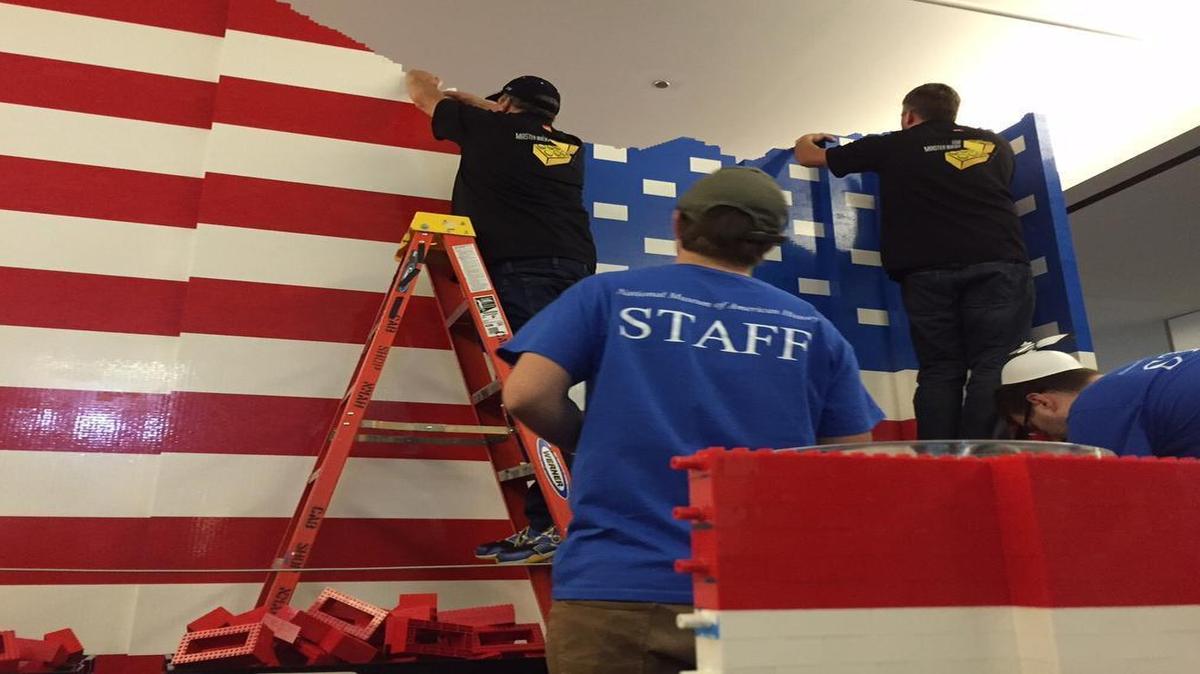 
Lego Master Builders working on the Lego American flag at the National Museum of American History. The flag was constructed as part of the opening festivities for the new Innovation Wing. 
