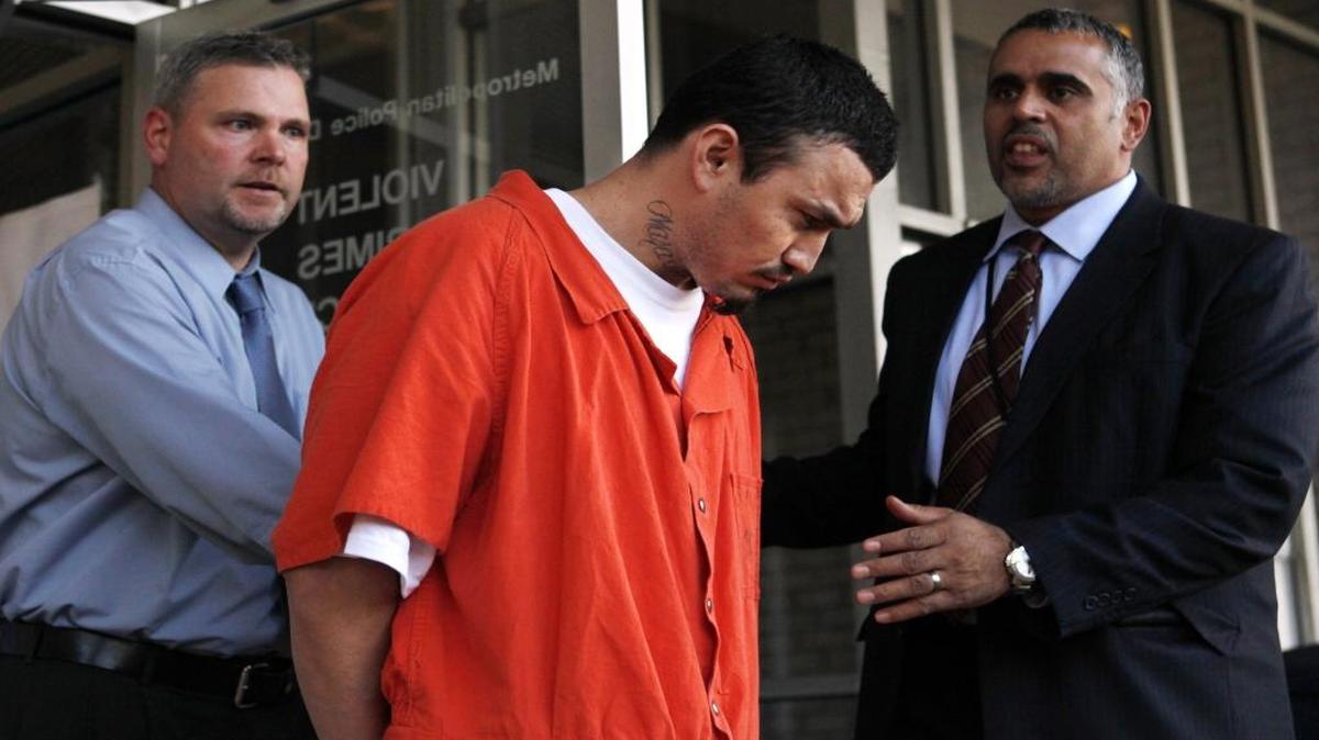 In this April 22, 2009, file photo, Ingmar Guandique is escorted from the Violent Crimes Unit in Washington. A judge has set a new trial date for the man convicted of killing Washington intern Chandra Levy.