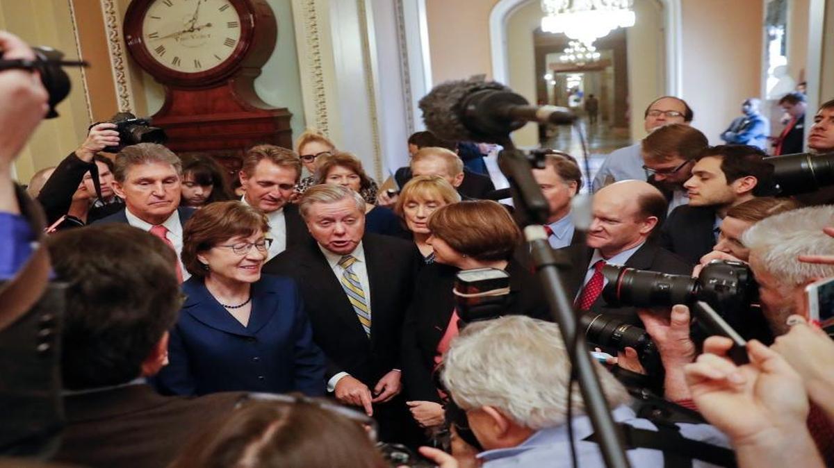 Sen. Lindsey Graham, R-S.C., center, speaks to members of the media outside the Senate Chamber on Capitol Hill in Washington Monday after reaching an agreement to advance a bill ending the government shutdown. With Graham are from left, Sen. Joe Manchin, D-W.Va., Sen. Susan Collins, R-Maine, Sen. Jeff Flake, R-Ariz., Sen. Lisa Murkowski, R-Alaska, Sen. Maggie Hassan, D-N.H., and Sen. Chris Coons, D-Del.
