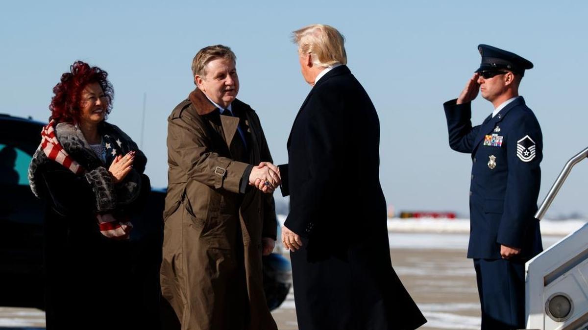 Congressional candidate Rick Saccone and his wife Yong Saccone greet President Donald Trump greet President Donald Trump as he arrives at Pittsburgh International Airport.