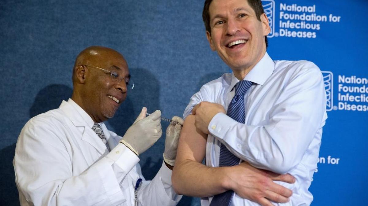 
Centers for Disease Control and Prevention Director Dr. Tom Frieden, right, laughs as he receives a flu shot from nurse B.K. Morris during an event about flu vaccinations, Thursday, Sept. 17, 2015, at the National Press Club in Washington. It's time for flu shots again, and health officials expect to avoid a repeat of the misery last winter, when immunizations weren't a good match for a nasty surprise strain. 

