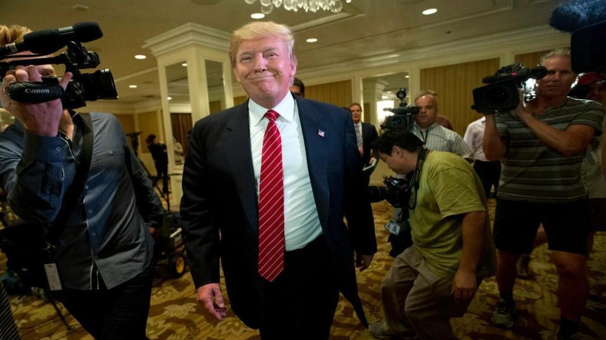 In this July 10, 2015 file photo, Republican presidential candidate Donald Trump smiles as he leaves after speaking at a news conference about immigration, in Beverly Hills, Calif. California Democrats hope to cash in at the polls against Republican members of Congress considered vulnerable to Latino sentiment against Trump.