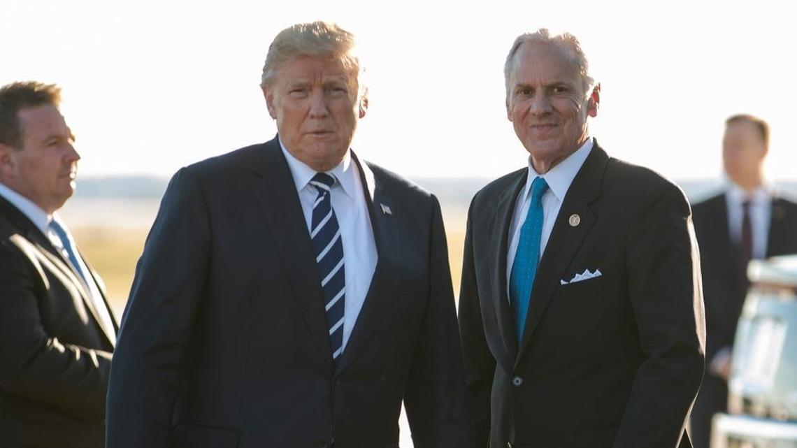 President Donald Trump stands on the tarmac with South Carolina Gov. Henry McMaster as he arrives on Air Force One at Greenville Spartanburg International Airport, in Greer, S.C., in October for a fundraiser for McMaster.