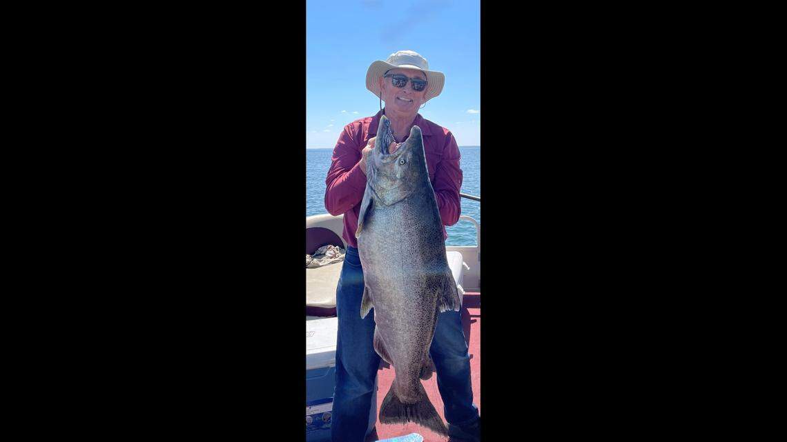 Jim Fauth is pictured holding his state record-breaking catch: a Chinook salmon.