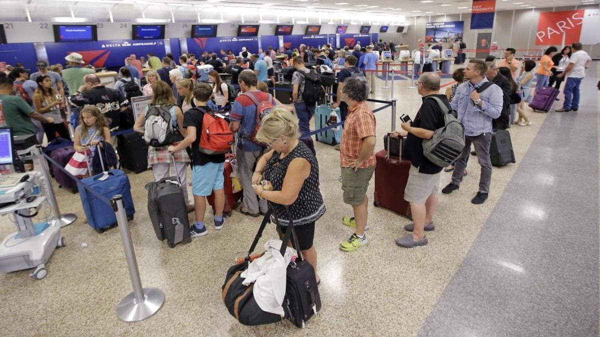 Delta Air Lines passengers stand in line after flights resumed in Salt Lake City, Utah, following a computer outage on Aug. 8, 2016. Delta Air Lines delayed or canceled hundreds of flights Monday after its computer systems crashed, stranding thousands of people on a busy travel day.