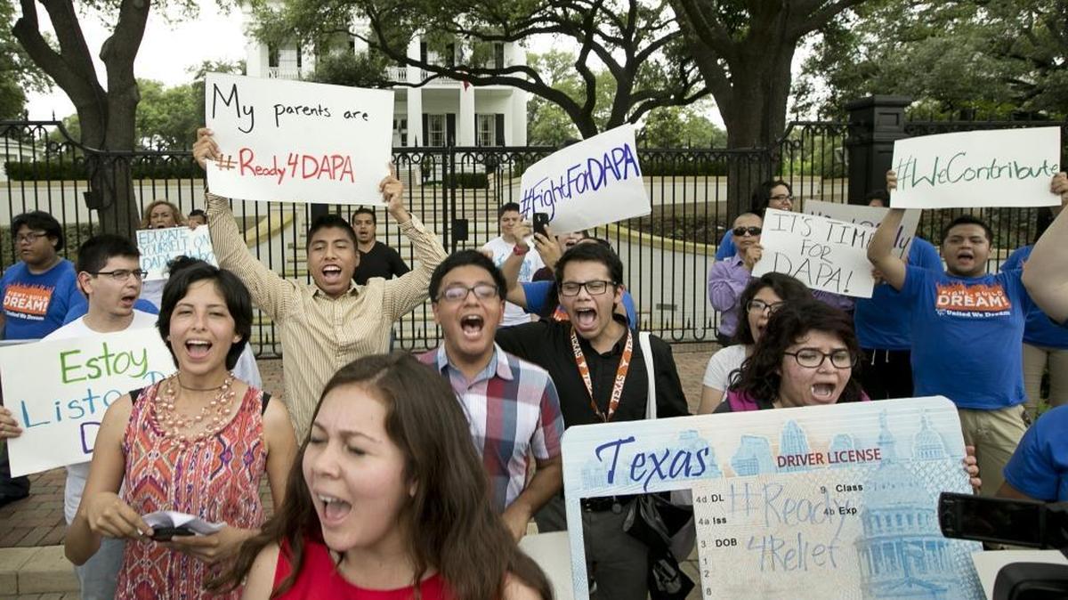 Immigrant rights activists chant outside the Governor’s Mansion in Austin, Texas, on Tuesday May 19, 2015, to protest the Texas lawsuit against the Deferred Action for Parents of Americans.