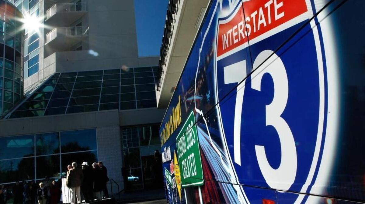 A Shrink-wrapped tour bus with Interstate 73 promos was a backdrop as Myrtle Beach area leaders gathered Friday at the Myrtle Beach Convention Center to encourage residents to be "cheerleaders" for Interstate 73 and other infrastructure projects this weekend when candidates are in town for the Republican Presidential Debate.