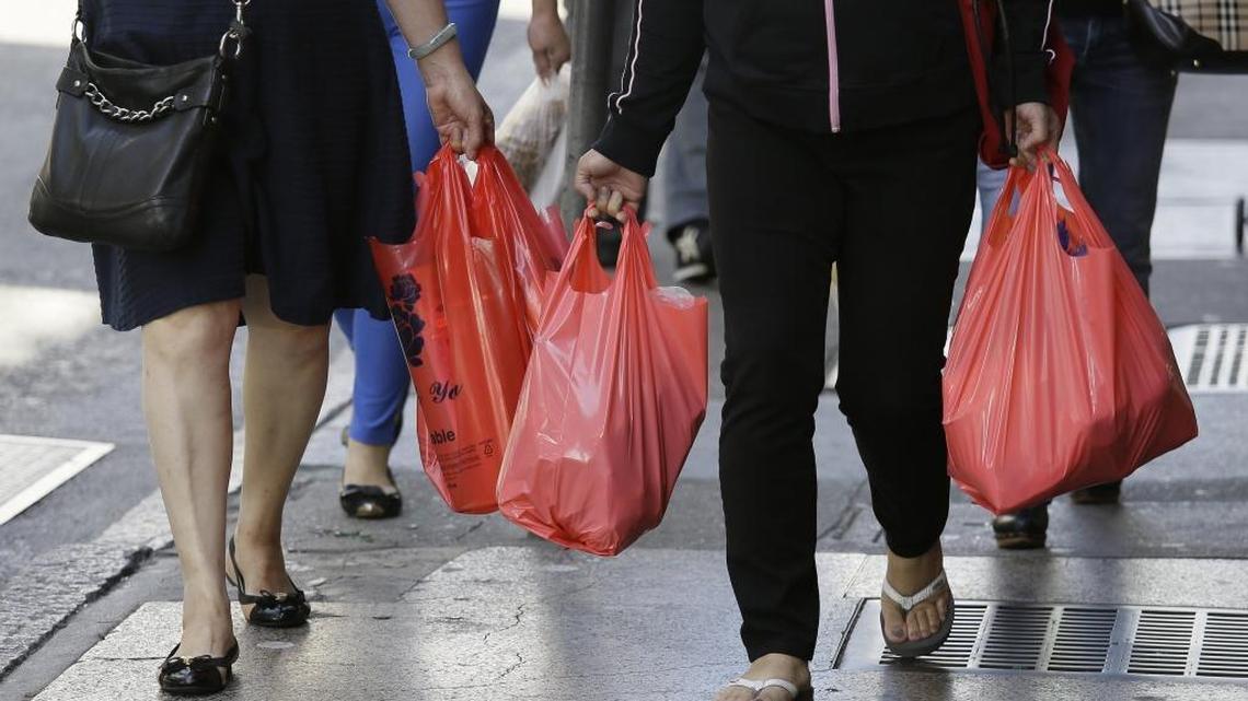 In this Sept. 20, 2016, file photo, women walk with plastic bags through Chinatown in San Francisco.